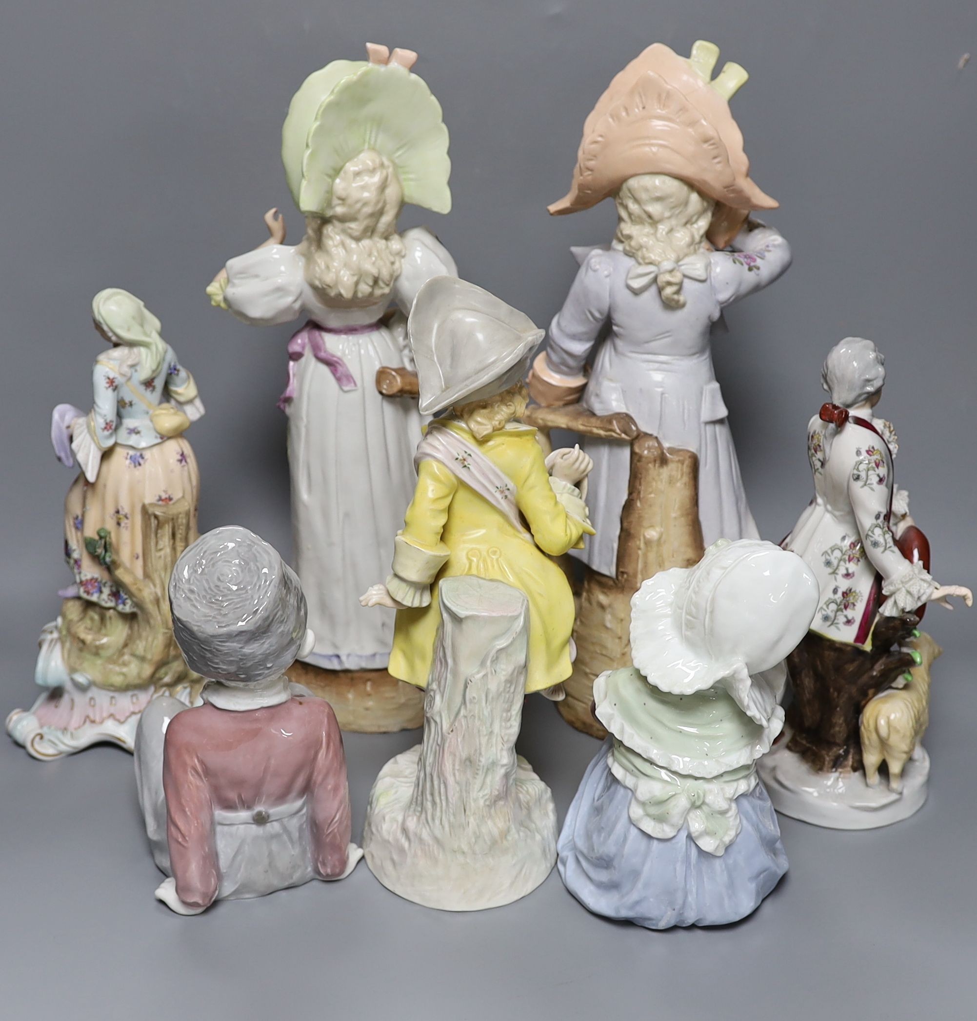 A collection of German and French porcelain figurines, tallest 39.5cm high